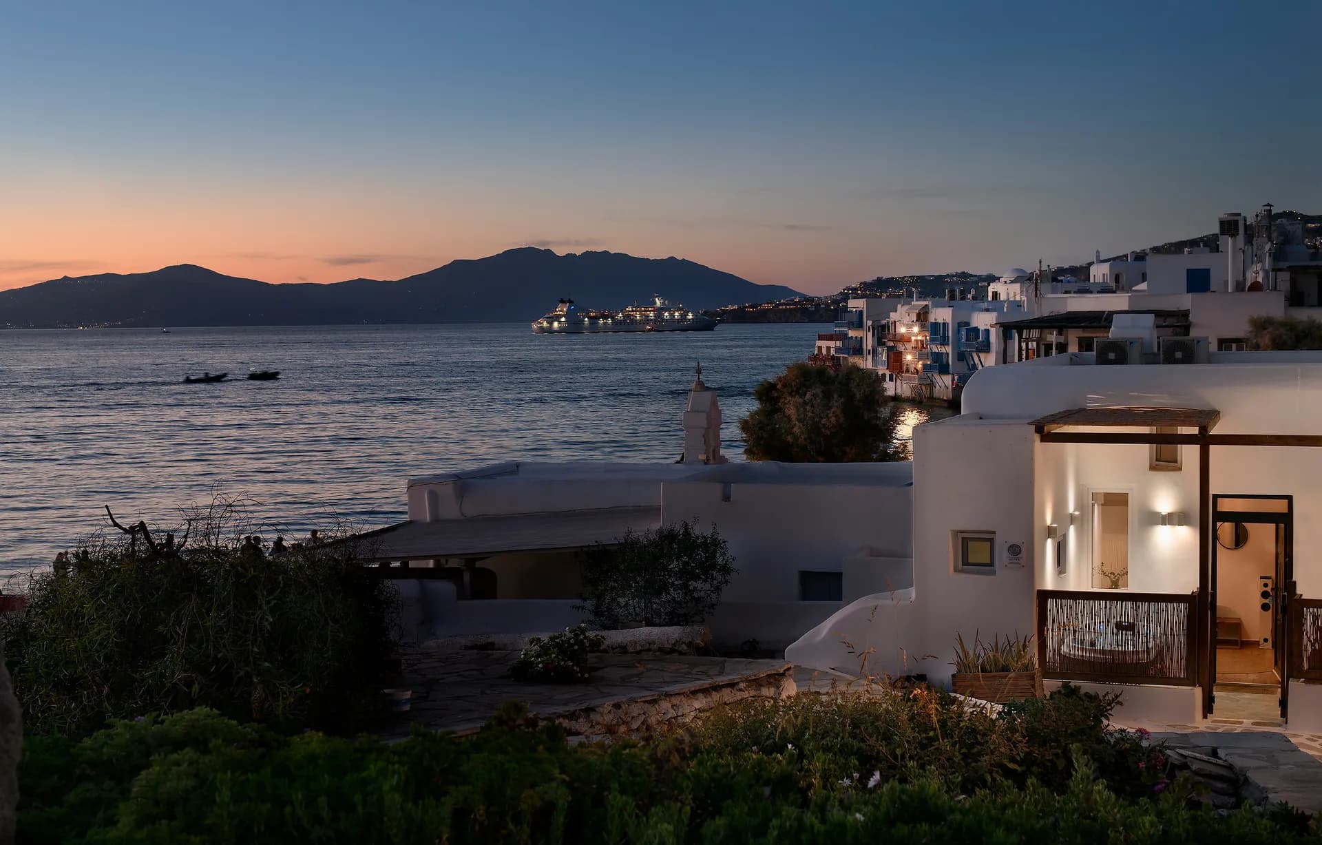 Mykonos Town waterfront and the maisonette lit up at sunset