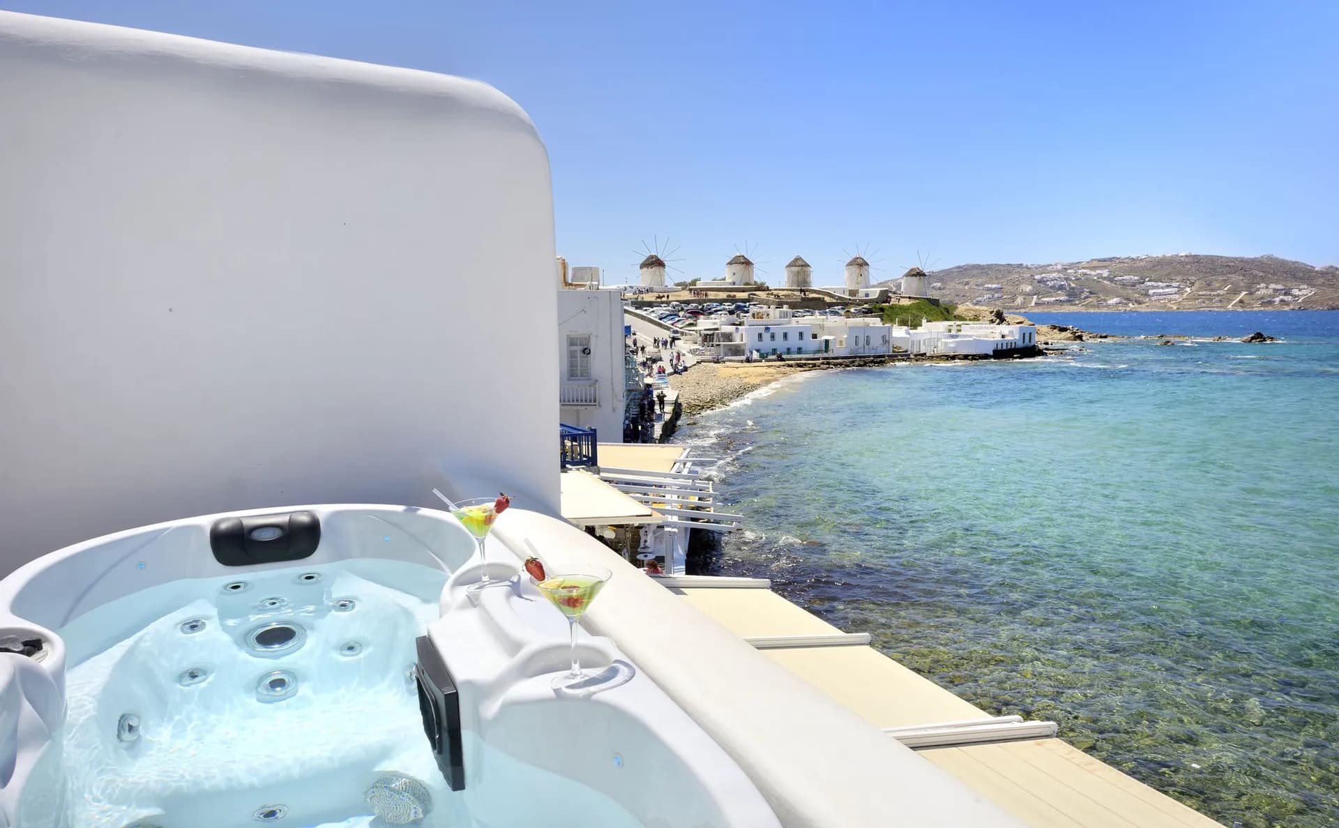 Outdoor Jacuzzi on a terrace overlooking the sea and the Mykonos windmills